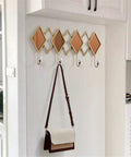 Real Deal Nordic Wrought Iron Wall Hooks For Coats And Keys Heavy Duty Build, hanging brown and white bag on decorative wall hook.