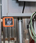 Klein Tools 935DAG digital level installed on a metal frame, orange display showing 180.0°
