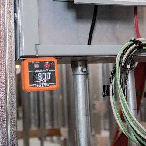 Klein Tools 935DAG digital level installed on a metal frame, orange display showing 180.0°