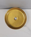 Top view of round golden counter basin, a sleek bathroom sink perfect for modern art designs in hotel apartments.
