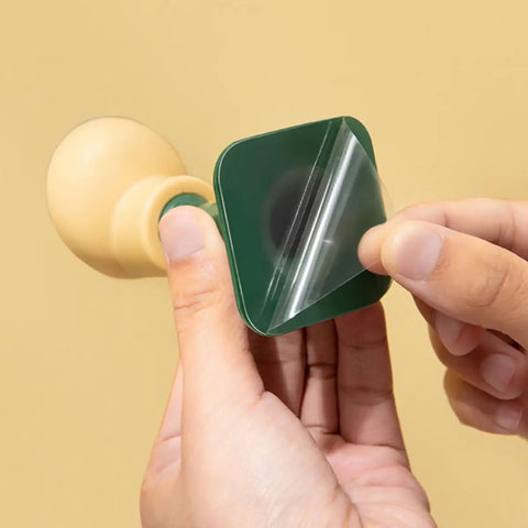 Applying adhesive backing of Wall Mounted Door Stopper Set Four Pack, Non Slip PP and TPR material, anti-collision design