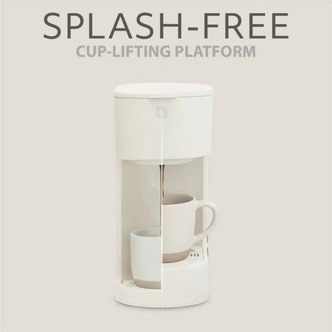 Front view of Eco Series Single Serve Coffee Maker For K Cup And Ground Coffee With Six To Twelve Oz Brew Sizes And Strong Brew Option Compact Coffee Machine With Removable Water Reservoir And Reusable Filter Made From Recycled Plastic showing splash-free cup-lifting platform.