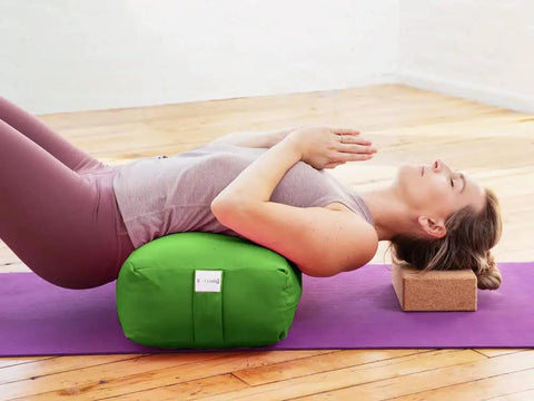 Rectangular Yoga Bolster Pillow For Restorative Yoga And Meditation, Extra Firm Cotton Cushion That Props Hips, Knees, And Back, Large Floor Pillow 28 By 12 By 8 Inches For Home Practice And Meditation. Woman using green cotton bolster for supported backbend