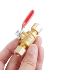 Brass ball valve shut-off with red lever; close-up view, 1/4" compression x 1/4" compression straight tubing fittings