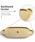 Close-up of champagne bronze cabinet backplate with locator feature from 6 Pack Champagne Bronze Cabinet Backplate Set With 1.3 Inch Zinc Alloy Drawer Knobs And Screw Accent Oval Backplates Sleek Durable Dope Hardware For Kitchen And Bathroom Furniture.