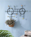 Heavy Duty Wall Mount Coat Hooks Built Tough With Premium Iron Metal in black, featuring a modern design and decorative plant.