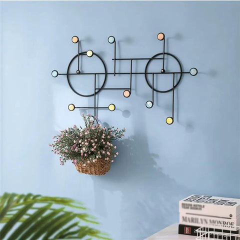 Heavy Duty Wall Mount Coat Hooks Built Tough With Premium Iron Metal in black, featuring a modern design and decorative plant.