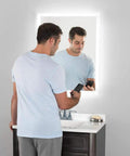 Man using LED Bathroom Mirror With Bluetooth Speakers Frameless Wall Mounted Vanity for music and grooming