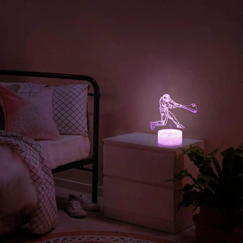 Baseball Man 3D Lamp Night Light With Remote Control And Touch Sensor on bedside table, soft pink glow, kids' bedroom.