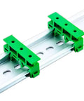 DIN Rail PCB Mounting Bracket Carrier Clip For C45 Boards 35mm By 15mm shown installed on rail, green color