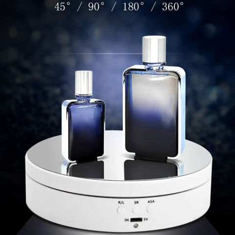 KobeIeen Electric Jewelry Turntable Display With 3 Speed Settings, Battery Powered Rotating Stand For Watches And Cosmetics, Sleek Mirror Finish One Button Control Sturdy Ab Building Perfect Gift Idea showcasing two perfume bottles on the rotating stand.