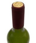 Premium Heat Shrink Wine Bottling Caps 100 Pack Matte Oriental Red on top of a green wine bottle, showcasing smooth satin finish.
