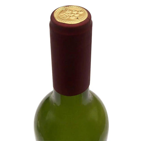 Premium Heat Shrink Wine Bottling Caps 100 Pack Matte Oriental Red on top of a green wine bottle, showcasing smooth satin finish.
