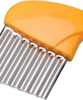 Yellow plastic-handled crinkle cutter with stainless steel wavy blade for potatoes and vegetables, close-up