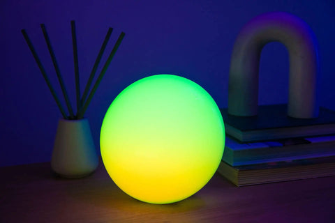 Smart Led Entertainment Lamp And Night Light With 16 Million Colors And Color Shifting Scenes For Desktop Or Nightstand glowing on a table