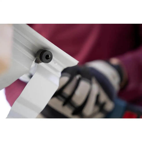 Close-up of 18V 16 Gauge Nibbler with brushless motor cutting metal sheet, showcasing rotating die holder for pro-grade sheet metal cuts