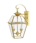 Outdoor wall lantern in brass with clear beveled glass and two lights, traditional sconce style.