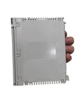 Heavy Duty Electric Power Supply Module TSXPSY2600 held in hand, compact grey design for industrial automation applications.