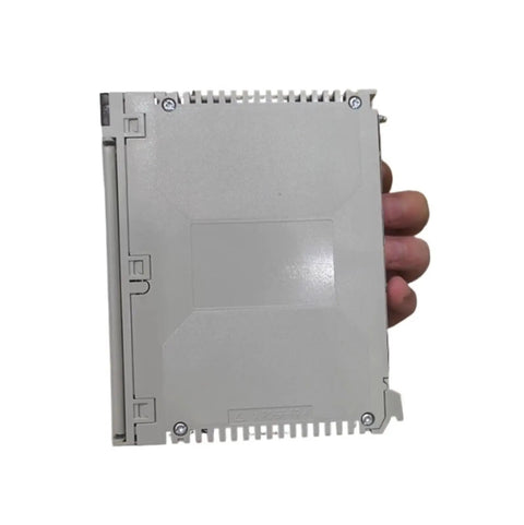Heavy Duty Electric Power Supply Module TSXPSY2600 held in hand, compact grey design for industrial automation applications.