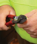 Close-up of hands using USA Made Wire Cutter, Stripper, and Crimp Tool with Shear Cutter on a wire.