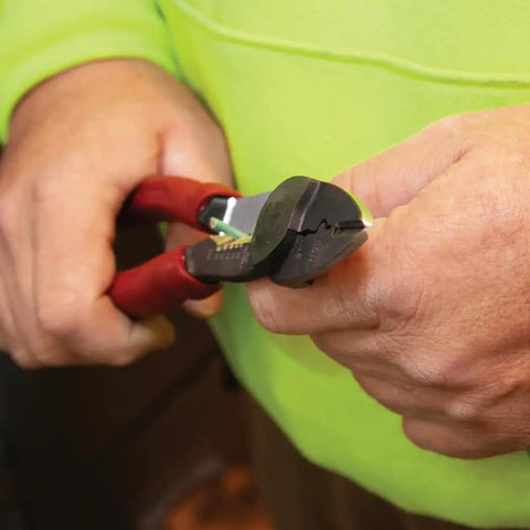 Close-up of hands using USA Made Wire Cutter, Stripper, and Crimp Tool with Shear Cutter on a wire.