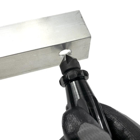General Tools hand reamer and countersink, short length, 3/4 in, black-handle bit positioned at metal block hole