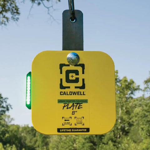 Flash Bang Pro Target Hit Indicator With Impact Light System on AR500 plate outdoors with LED feedback, for shooting practice.