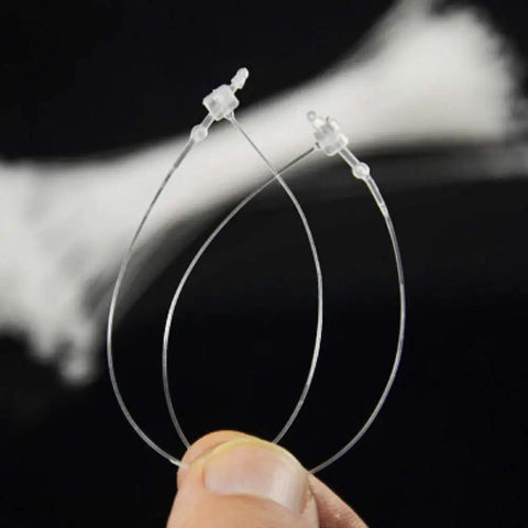 Five Thousand Piece Set Of Five Inch Natural Snap Lock Loop Lock Fasteners, clear plastic, for securing tags on bags and crafts.