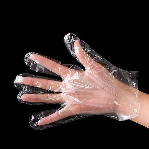 Front view of a hand wearing a clear disposable plastic food-prep glove.