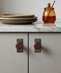 Nordic Style Cabinet Handles in walnut wood and zinc alloy for kitchen drawers, ergonomic single hole mount, visible on white cabinets
