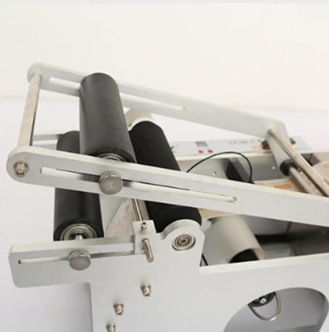 Close-up view of Semi Auto Round Bottle Labeling Machine For 15-30 Pcs Per Minute Speed with rollers and aluminum alloy frame.