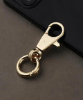 Top Tier Heavy Duty Double Opening Snap Hooks With Smooth Swivel Lobster Clasp Keychain Clip Gold Hardware close-up on surface.