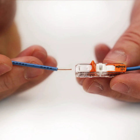 Inserting wire into Lever Nut Wire Connector Set 221 Series 35pc Compact Splicing Kit for quick connection.