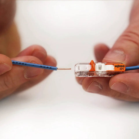 Hands using Lever Nut Wire Connector Set 90-Piece Compact Splice Kit With Case for wiring a copper wire into Wago 221 connector