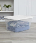 Kick The Junk Clutter Aside With These Ridiculously Spacious Clear Plastic Storage Containers Featuring Hassle Free Snap On Lids Straight Outta The Box Ready To Tame Your Garage Tools And Closet Stash Massive 58 Quart Capacity 8 Pack Included clear plastic storage container with blankets inside on wooden floor.