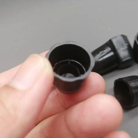 Close-up of a 8 Pack Fifteen Millimeter Bike Hub Axle Dust Covers Replacement End Caps For Bicycle Wheel Nuts Inner Diameter 15 Mm