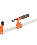 Twelve Inch Steel Bar Clamp With Instant Adjustment And Lightweight Orange Finish One Quarter Inch By Three Quarter Inch Spring Steel Bar Ideal Woodworking Clamp For Quick Grips And Grab And Go Setup, orange steel bar clamp on white background