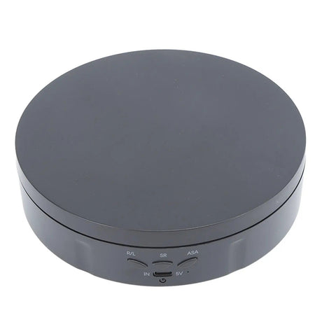 Must Have Remote Controlled 360 Rotating Turntable For Jewelry Photography And Live Streaming With Adjustable Speed Silent Motor Operation top view in black, showcasing buttons and charging port.