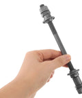 Hand holding Beefy 180mm Mountain Bike Rear Axle With Titanium Alloy Shaft Hollow Hub And Ball Bearing Kit for mountain biking DIY repairs.