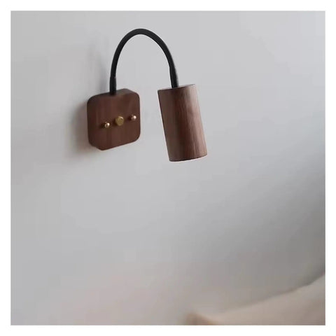 Modern Walnut Wall Sconce With 360 Degree Swivel Spotlight Brings Chill Vibes To Bedrooms And Living Rooms While Delivering Smooth Adjustments For Aisles That Makes Installation A Breeze Today, featuring a cylindrical light on a wooden base.