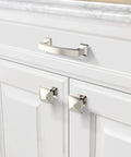 Modern silver cabinet handle on white kitchen drawer with matching knobs