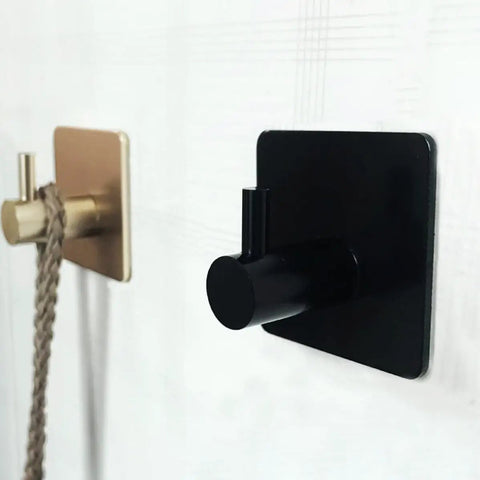 Rock Solid Black Stainless Steel Adhesive Wall Hook For Coats Towels And Umbrellas With No Hassle Peel Stick Mount on wall.