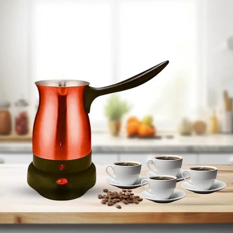 Electric Turkish Coffee Pot Kettle With Cool Touch Handle And Stainless Steel Body Travel Size 0.3L Fast Boil In Minutes And Keeps Water Boiling For Arabic Greek Coffee And Tea Red on kitchen counter with cups of coffee and coffee beans.