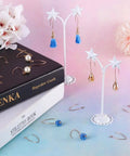 Rose Gold V Shape Stainless Steel Earring Hooks French Ear Wire 304 Stainless Steel Dangle Hooks With Loop 25.5x15x0.8mm Pin 0.8mm 10 Pcs For Women DIY Jewelry Making displayed on table with floral decorations