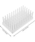 Compact Plastic Test Tube Peg Drying Rack And Laboratory Bench Organizer Straight Up Heavy Duty Science Lab Draining Stand for drying test tubes on a counter.