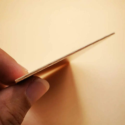 Side view of a single piece from the Fifteen Pack FR4 Copper Clad Blank PCB Laminate 70 By 100 By 1.5mm Single Sided Circuit Board.