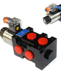 Front view of a 12V DC hydraulic solenoid selector valve: black block with red caps, silver solenoid coil, blue label.