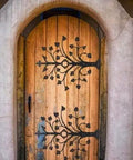 Kick Ass Wrought Iron Door Hinges With Glossy Black Powder Coating on decorative wooden door with tree design.