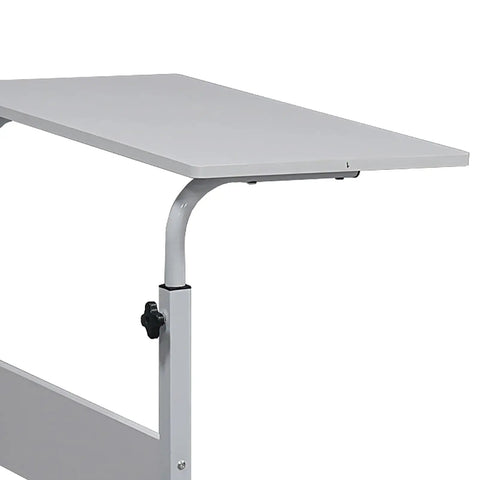 Adjustable standing computer desk featuring smooth locking wheels and foldable design for cozy living room setups.