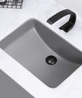Straight Up Heavy Duty Ceramic Sink, Square Under Counter Wash Basin, Solid Gray Pedestal Sink with black faucet on marble countertop.